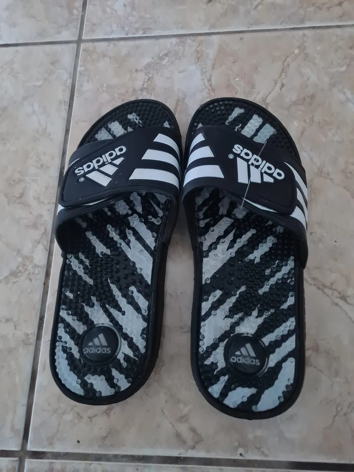 Photo de l'annonce : claquettes Adidas noires et blanches. — Ouangani (Mode)